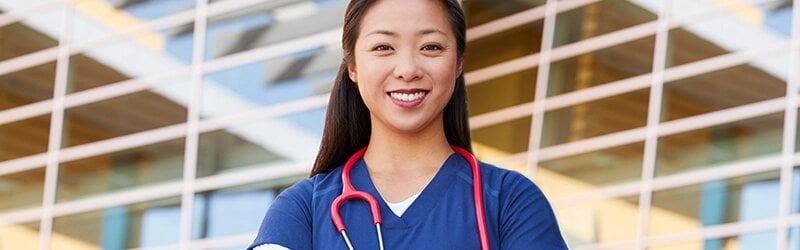 Nurse in front of building